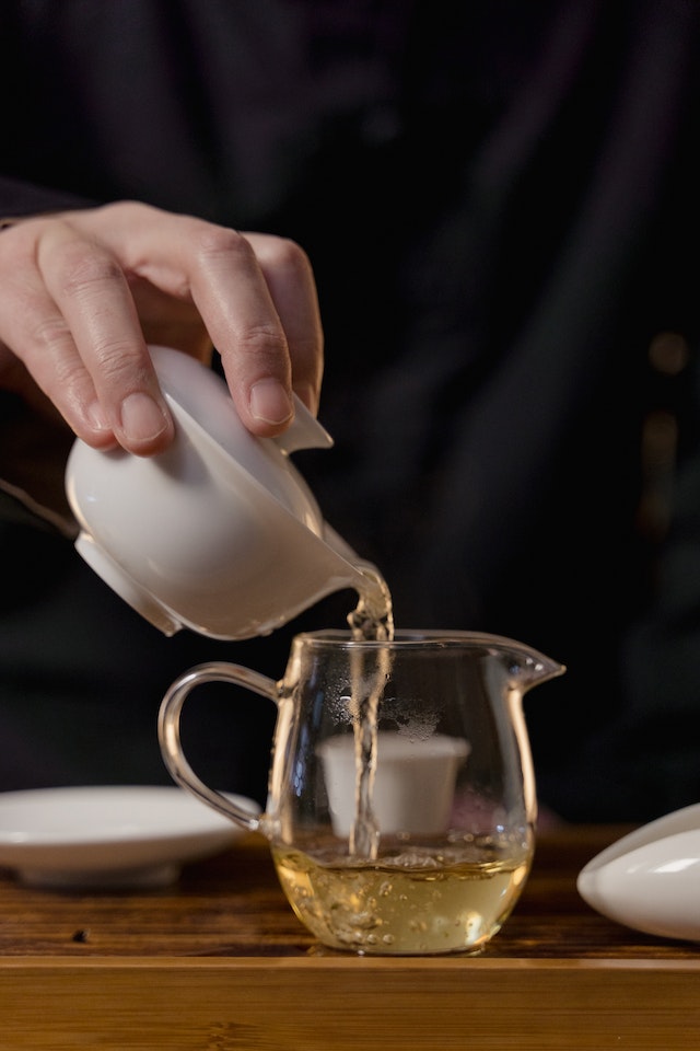 Green tea being poured into a pitcher