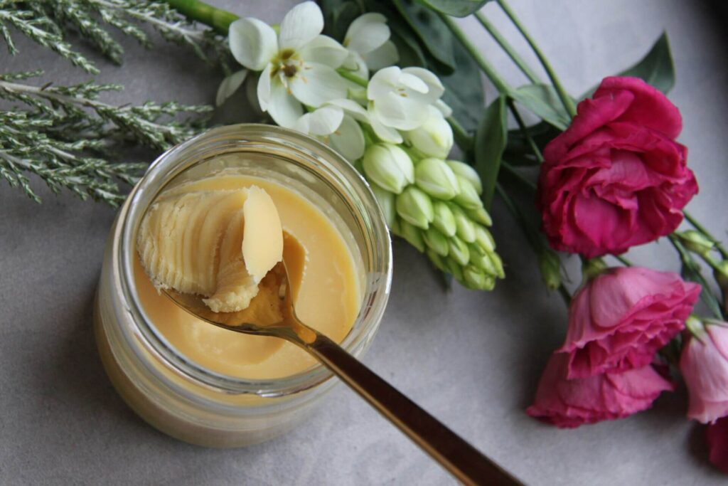 Butter being spooned from a jar.