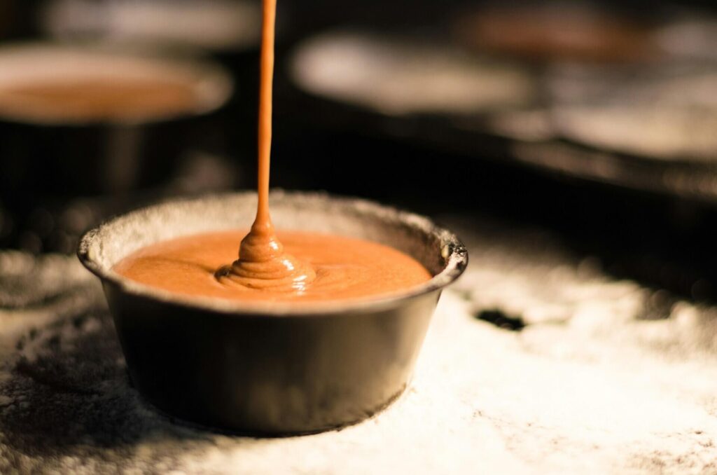 A container of caramel sauce.