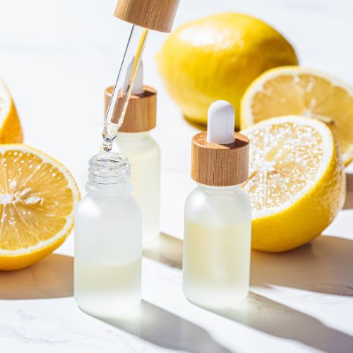 Lemon slices with extract being placed in a vial with a dropper.