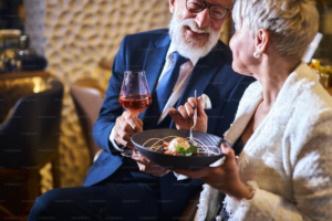 Two people enjoying wine and dessert