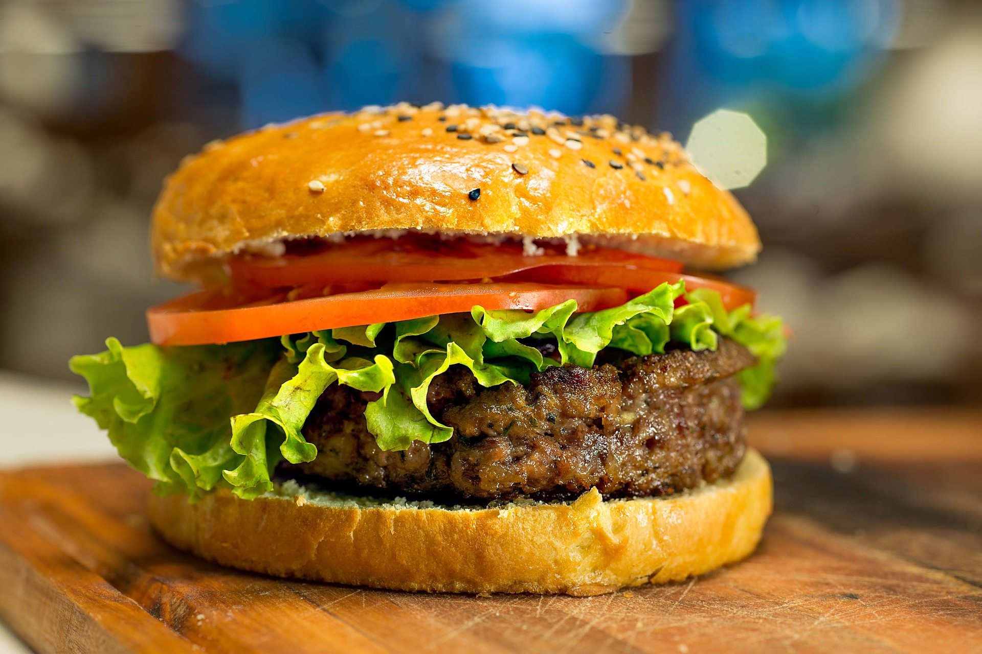Gourmet veggie burger with lettuce and tomato on a cutting board