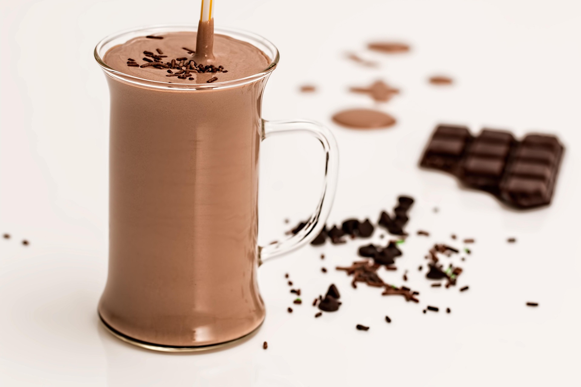 A chocolate smoothie with a pure cocoa bar in the background