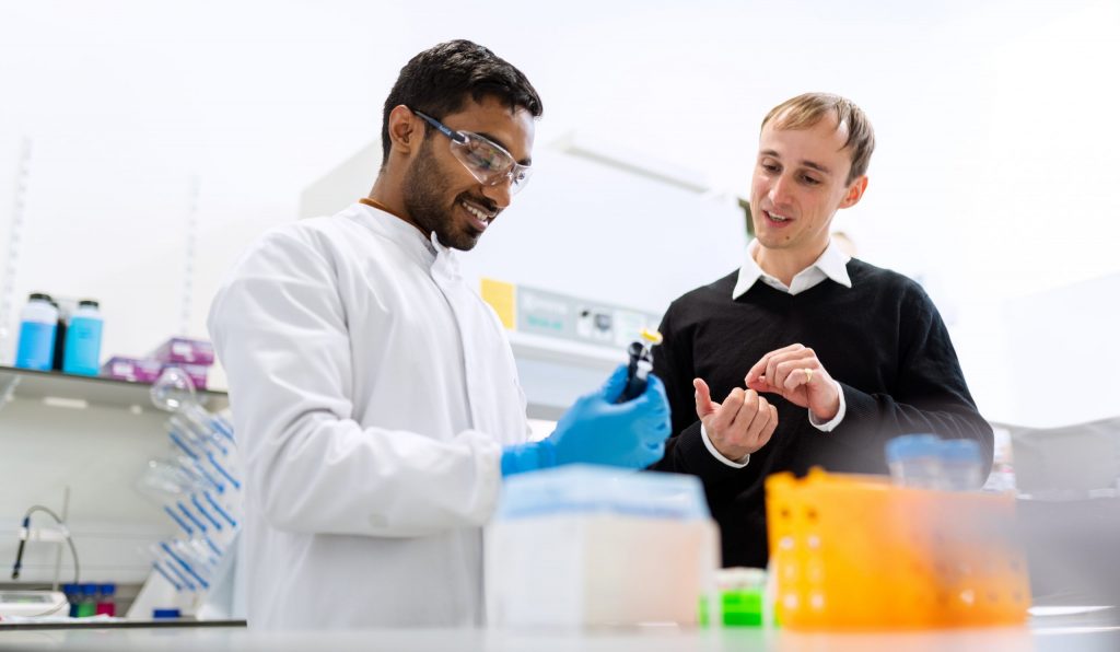 In a laboratory, flavor chemists discussing results.