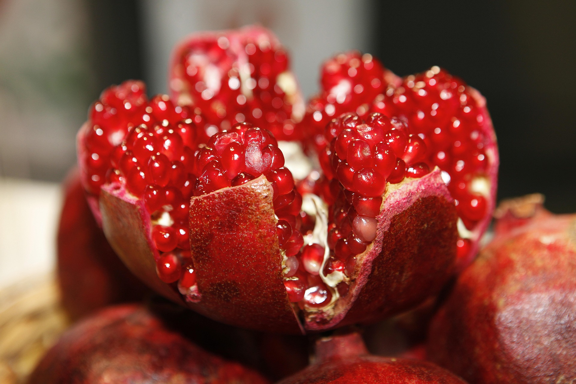 An open red pomegranate showing the seeds