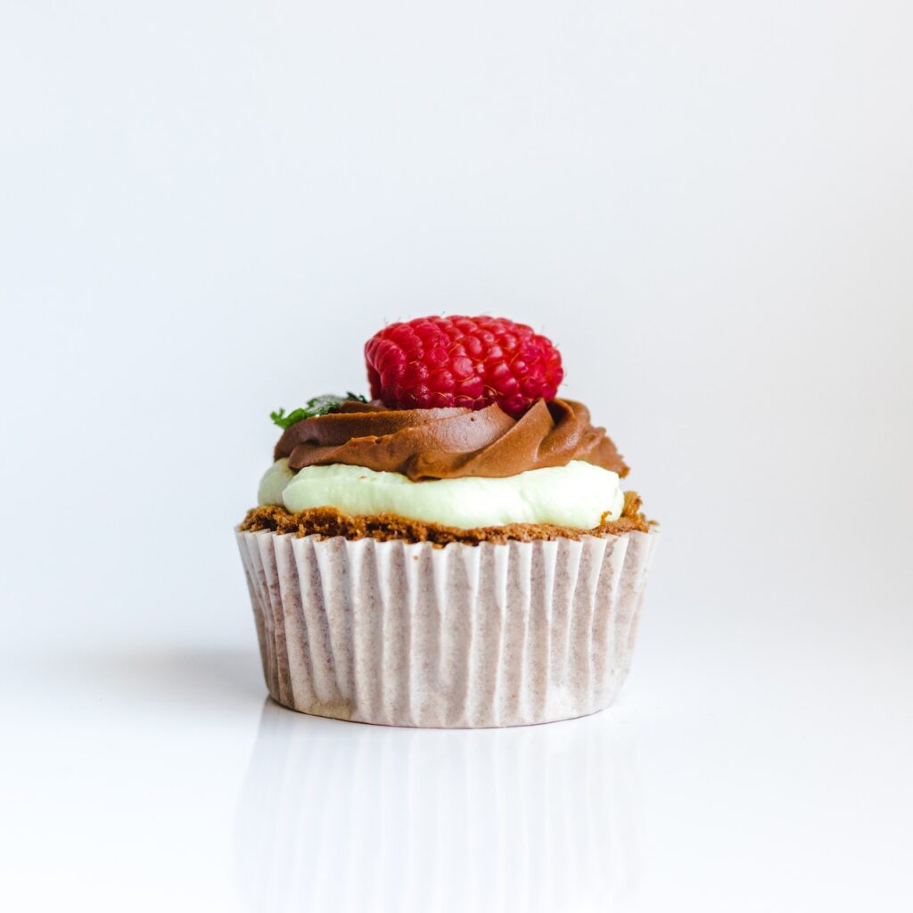 Decadent cupcake with a raspberry on top.