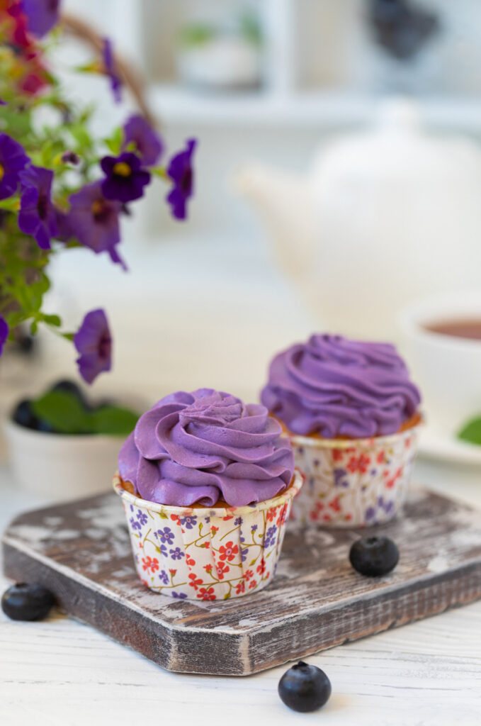 Two cups of purple ube ice cream with colorful sprinkles.